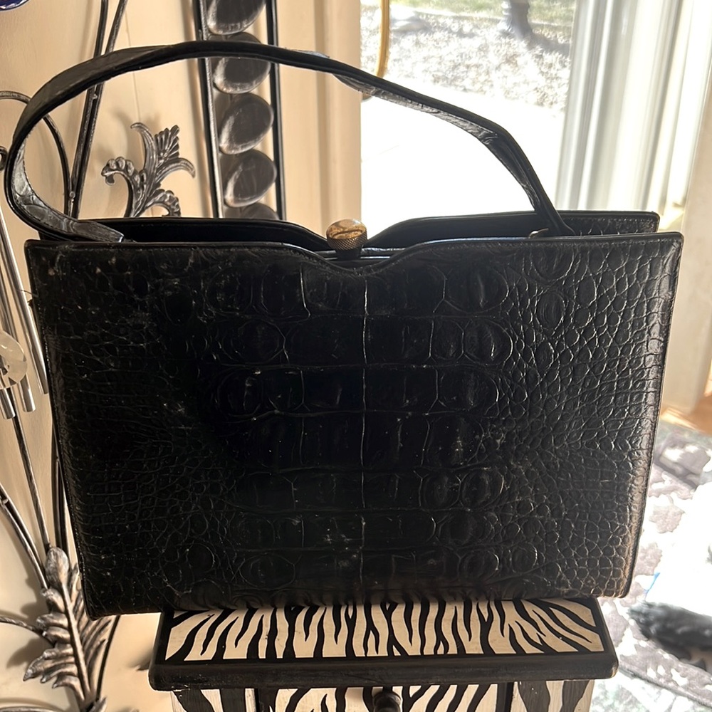 This is a beautiful well-maintained 9 x 12 black alligator purse.